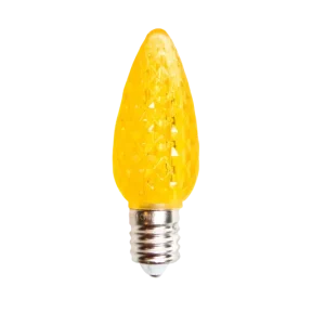 Close-up of yellow faceted C7 Minleon bulb on dark background