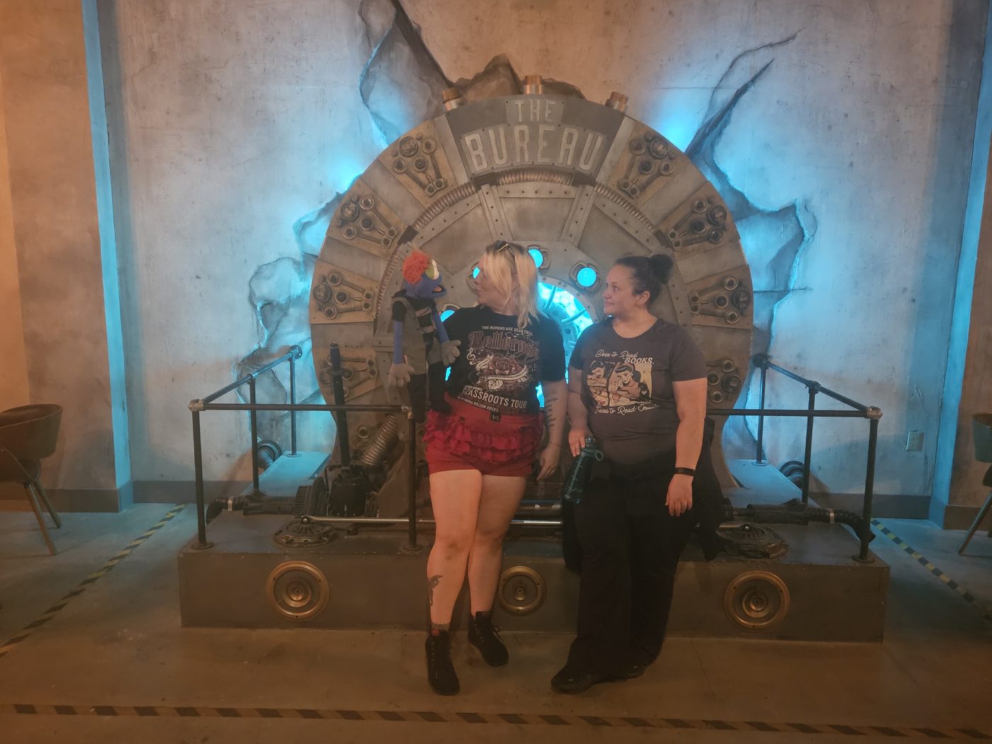 Rachel Klepadlo and a teammate in front of a vault door in an escape room