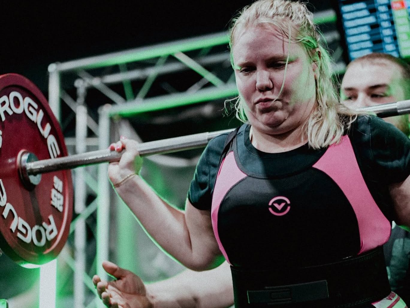 Rachel Klepadlo under a loaded barbell at a USA Powerlifting meet