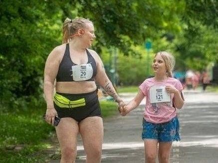 Rachel Klepadlo running a race holding hands with her daughter
